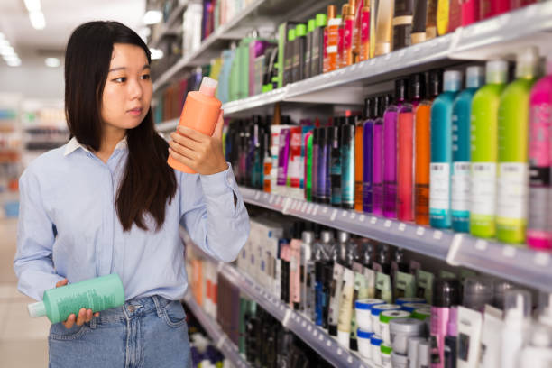 istock Asian girl choosing shampoo in store 1290249419