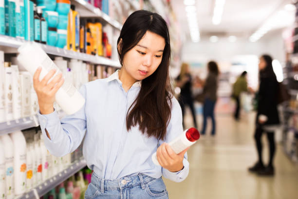 istock Asian girl choosing shampoo in store 1290249466
