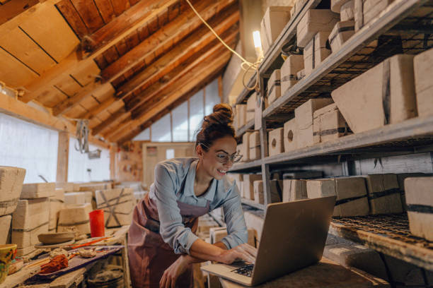 Female entrepreneur in her pottery sculpting studio