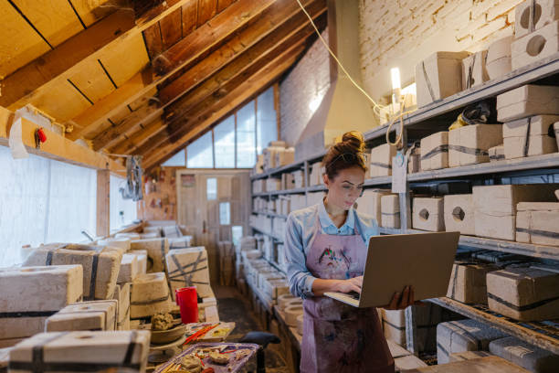 istock Female entrepreneur in her pottery sculpting studio 1290250522