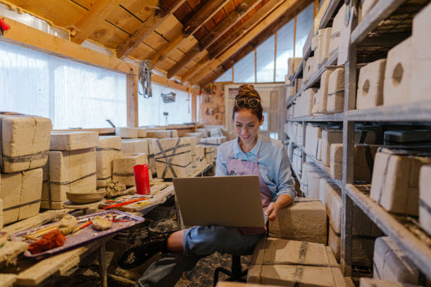 istock Female entrepreneur in her pottery sculpting studio 1290251356