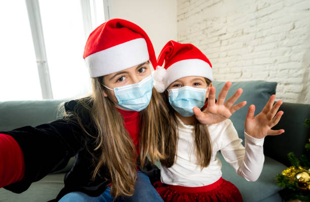 istock Sad and depressed children with mask at home bored at christmas feeling depressed missing family and friends. COVID-19 Lockdown, quarantine, stay home order, virtual christmas and mental health. 1290252049