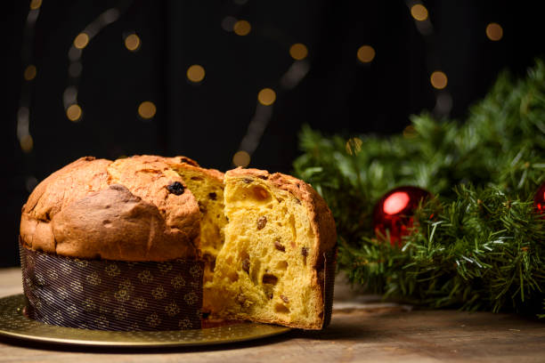 istock Handmade panettone on wooden table with Christmas decorations 1290252794