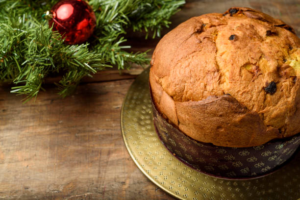 istock Handmade panettone on wooden table with Christmas decorations 1290252951
