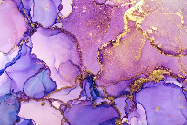 Photo of Closeup of purple and shiny golden alcohol ink abstract texture, trendy wallpaper