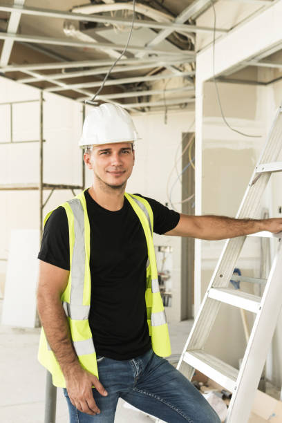 istock Worker wearing hard hat nad safety vest on a construction site 1290254145