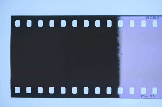 istock Dark Film Strip With Light Leak 1290254648