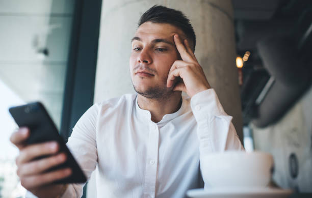 istock Thoughtful businessman browsing smartphone in cafe 1290256862
