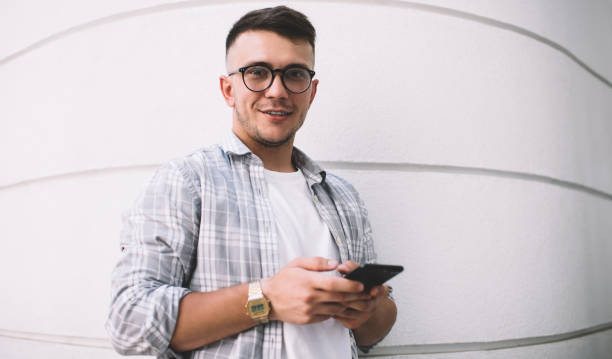 istock Happy young male using smartphone in daylight 1290256940