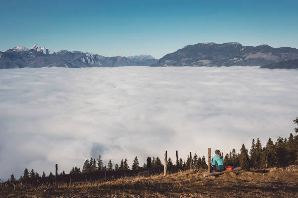 Lonely hiker looking at a view of fog covered valley