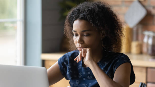 istock Thoughtful young african american woman working on computer. 1290259689