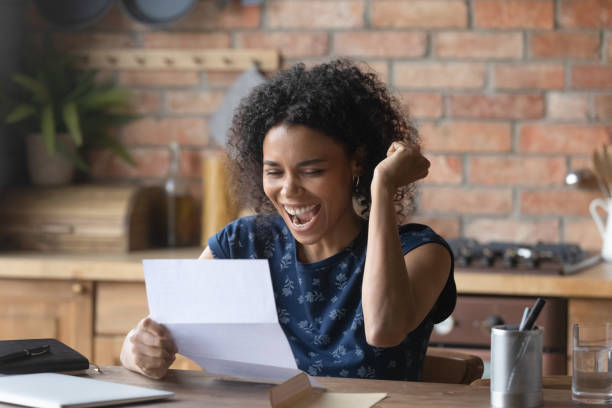 istock Euphoric overjoyed young mixed race african woman celebrating success. 1290259708