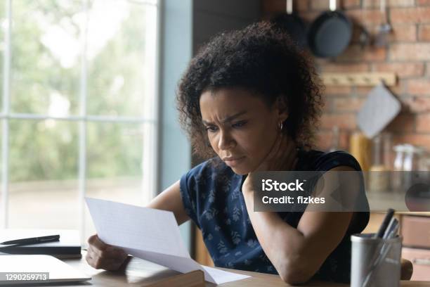 Frustrated Young African American Woman Reading Letter With Bad News Stock Photo - Download Image Now