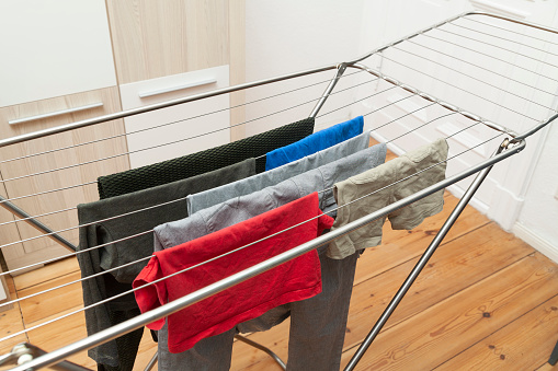 A few clothes on laundry rack