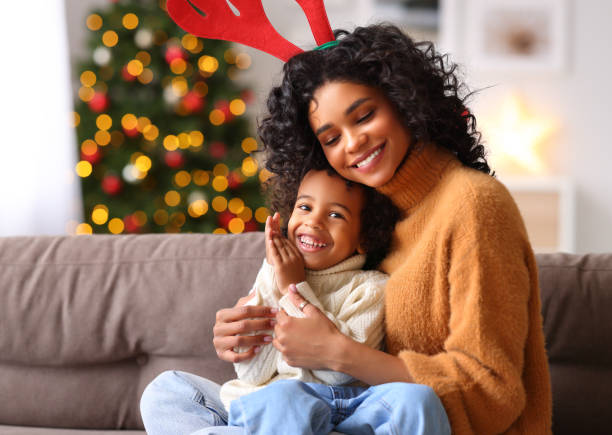 istock Mother and son playing and embracing on sofa on Christmas day 1290259833