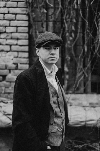 Portrait of a man in retro style. Peaky blinders. Vintage black and white photo