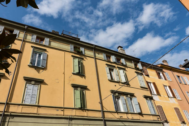 istock Yellow apartments white shutters in  Modena, Italy 1290262841