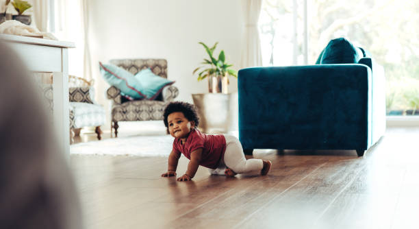 istock Cute baby crawling on floor 1290263895