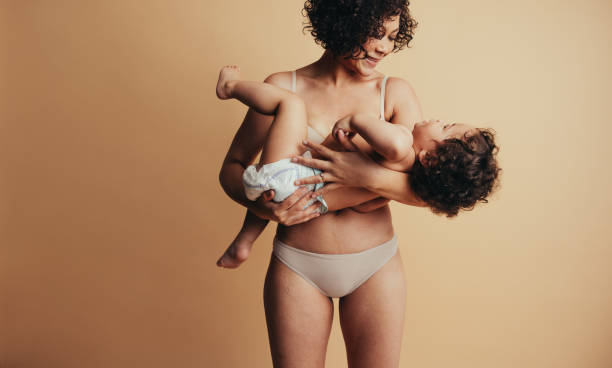 istock Loving mother carrying baby 1290264999