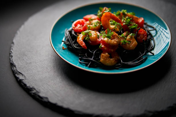 istock delicious fried shrimp with black spaghetti noodles 1290266285