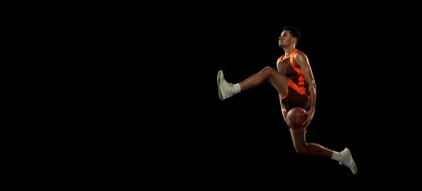 istock Young african basketball player training on black studio background. 1290266867