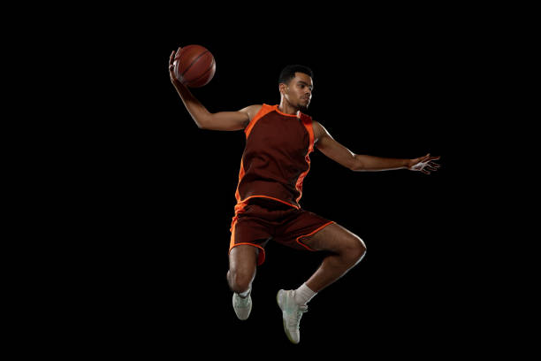 istock Young african basketball player training on black studio background. 1290266875