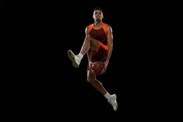 istock Young african basketball player training on black studio background. 1290266886