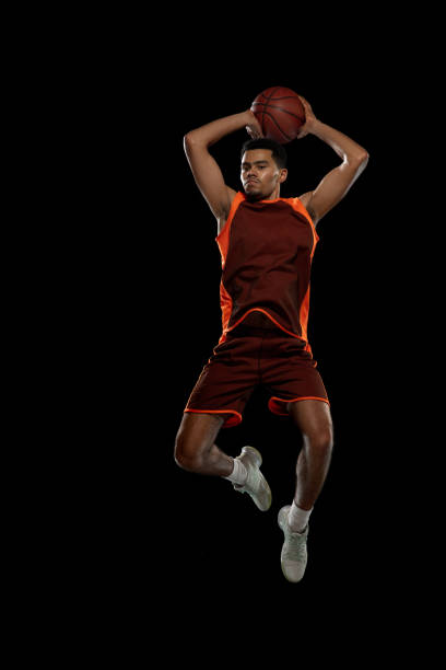 istock Young african basketball player training on black studio background. 1290266904