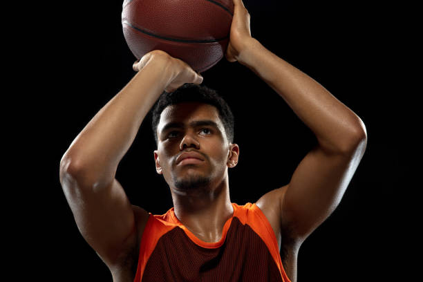 istock Young african basketball player training on black studio background. 1290266936