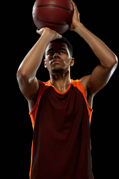 istock Young african basketball player training on black studio background. 1290266939