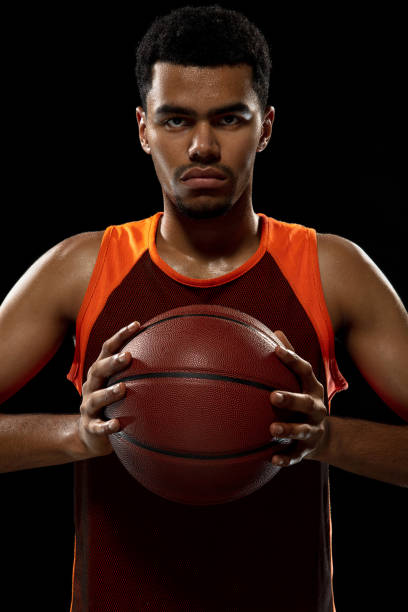 istock Young african basketball player training on black studio background. 1290266954