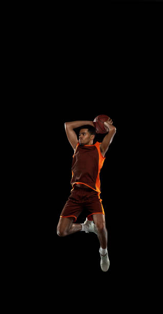 istock Young african basketball player training on black studio background. 1290266986