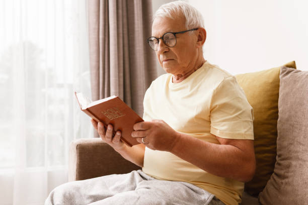 istock Elderly man reading holy bible 1290267646
