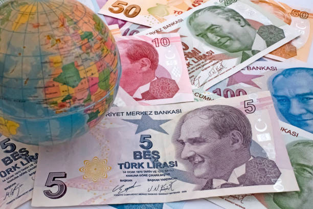 istock Close up Turkish lira banknotes with mini earth globe 1290267883