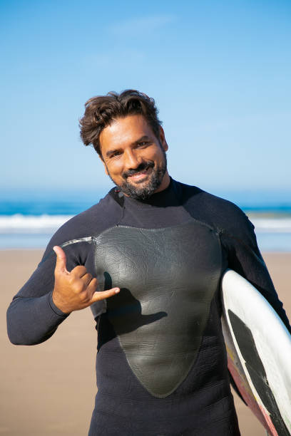 istock Portrait of happy bearded surfer posing with surfboard 1290268754