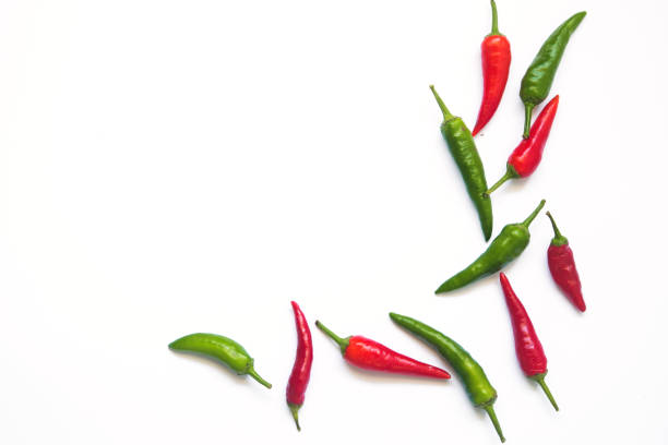 istock green and red hot chili peppers on a white background with space for text. 1290269206
