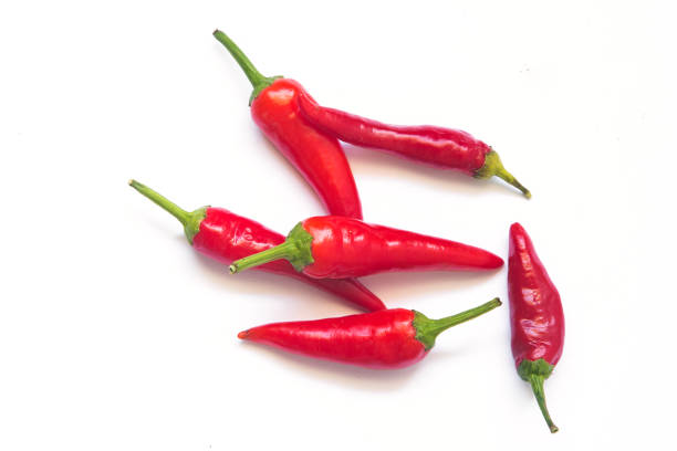 istock green and red hot chili peppers on a white background. 1290269213