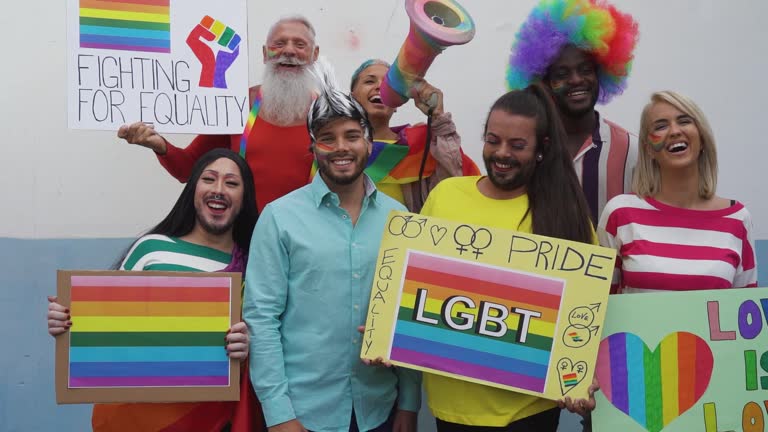 Happy Multiracial people celebrating gay pride event - Group of friends with different age and race fighting for gender equality - Lgbt protest concept