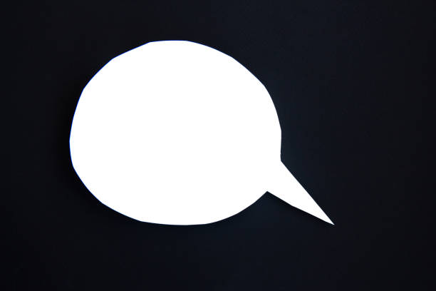 White paper speech bubble concept. Cartoon speech with clipping path on black background with contrasting shadow