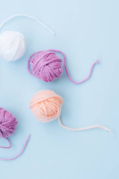 istock Several colorful skeins of thread on a light background 1290269654