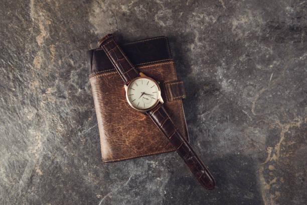 istock watch on the wallet on the table 1290271083