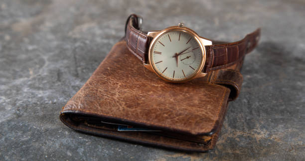 istock watch on the wallet on the table 1290271091