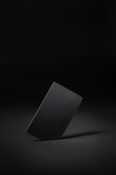 istock Blank black gift card isolated on black background 1290272443