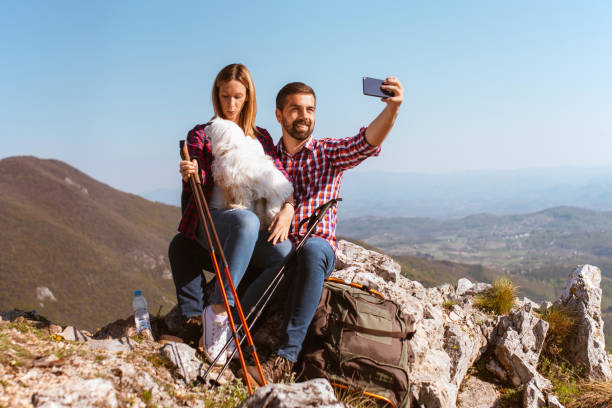istock Couple take selfie photo on mountain top 1290272600