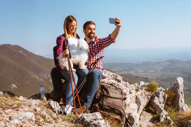 istock Couple take selfie photo on mountain top 1290272727