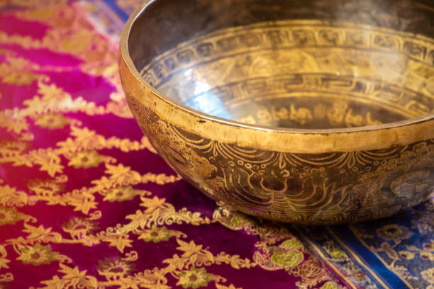 istock Tibetan bowl on decorative background, close-up with copy space. 1290274960