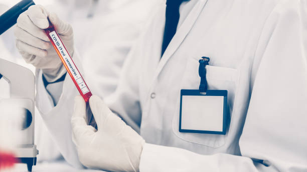 istock image of a scientist looking at a tube with a test 1290276014