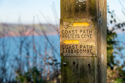 Torquay, UK. Sunday 6 December 2020. Coast Path Ansteys Cove and Babbacombe wooden post in Devon.