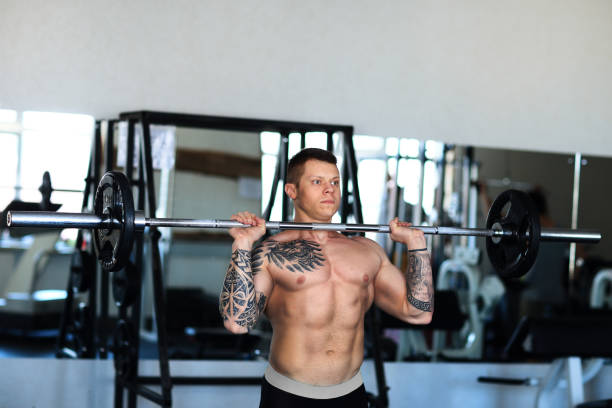 istock bodybuilder works with a barbell in the gym 1290277677