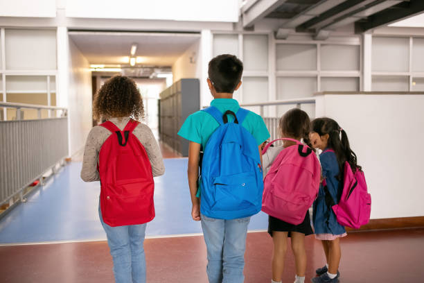 istock Group of schoolkids with colorful backpacks 1290278097